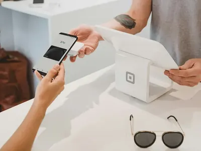 Customer paying at a counter illustrating Open Banking account-to-account payments for budget airlines